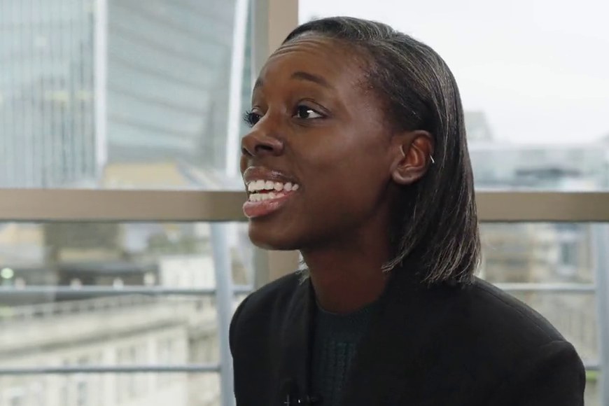 A char.gy team member smiling mid-answer in an interview, the City behind her