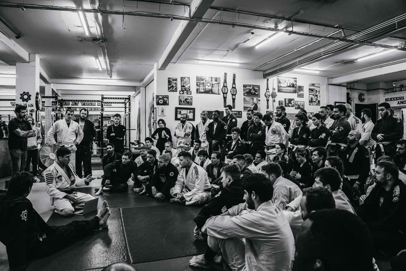 A packed gym in black and white during a combat sports shoot