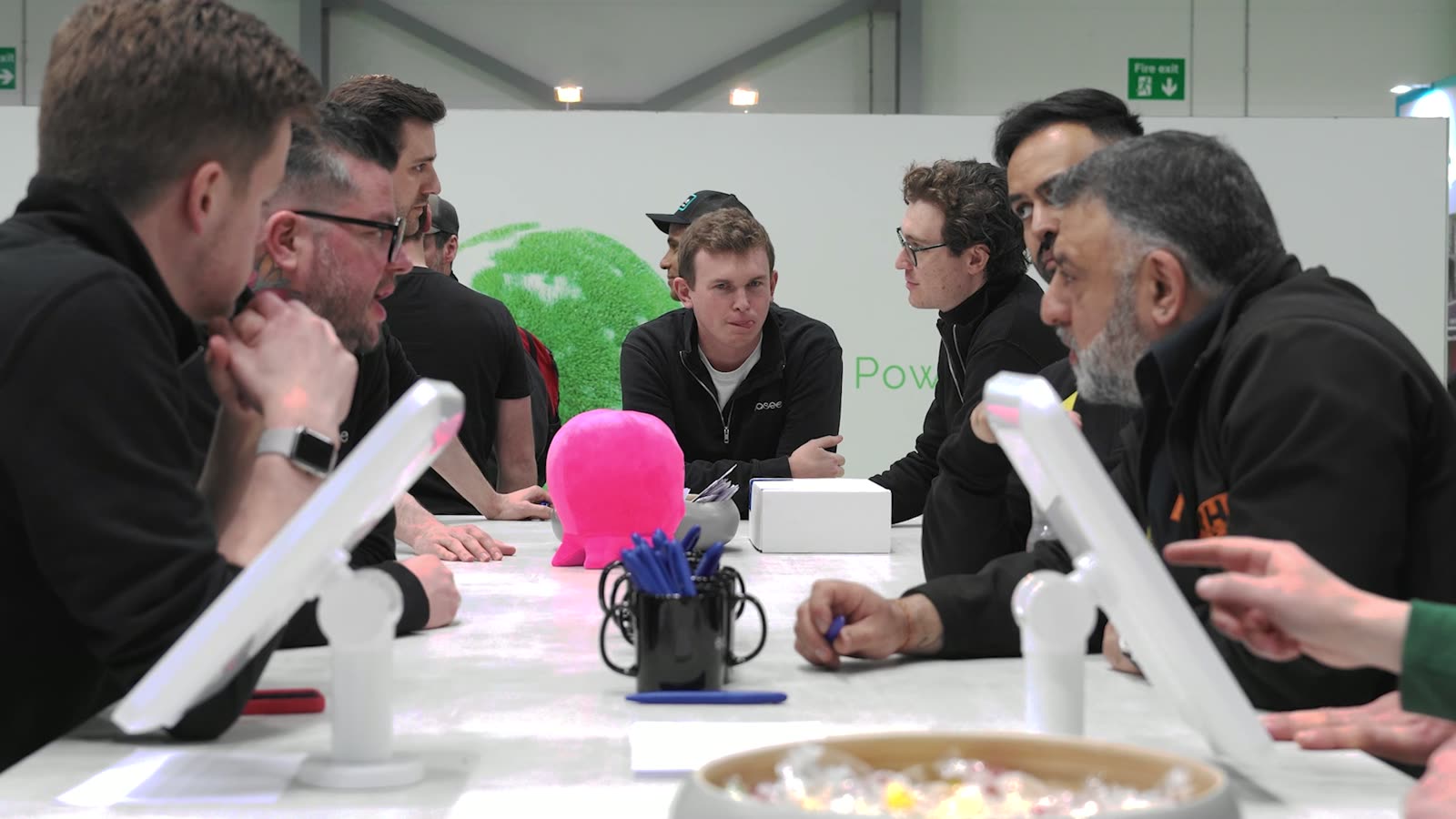 People in conversation round a table on an exhibition stand