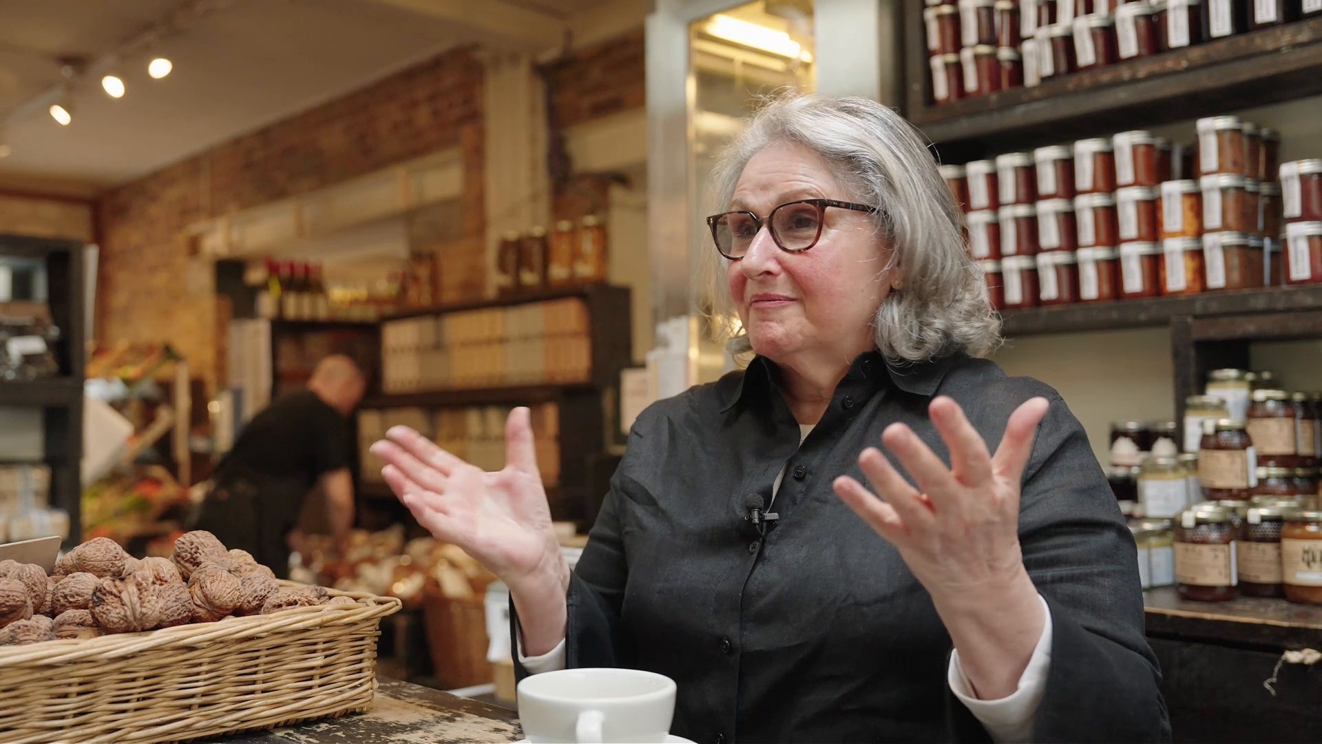 The founder of La Fromagerie talking on camera in her shop