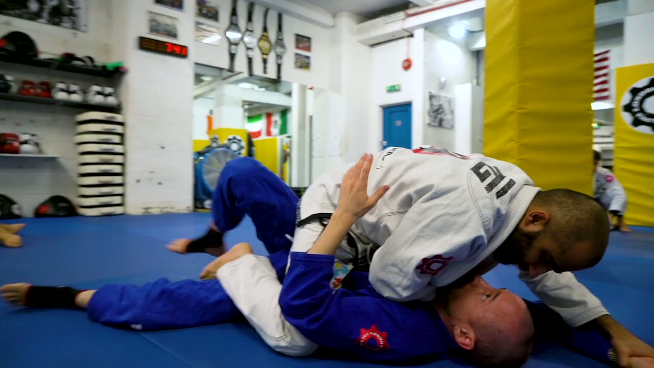 Two world champions teaching on the mat at a seminar